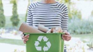 aware woman separating paper other waste ways to help the environment | Featured Image