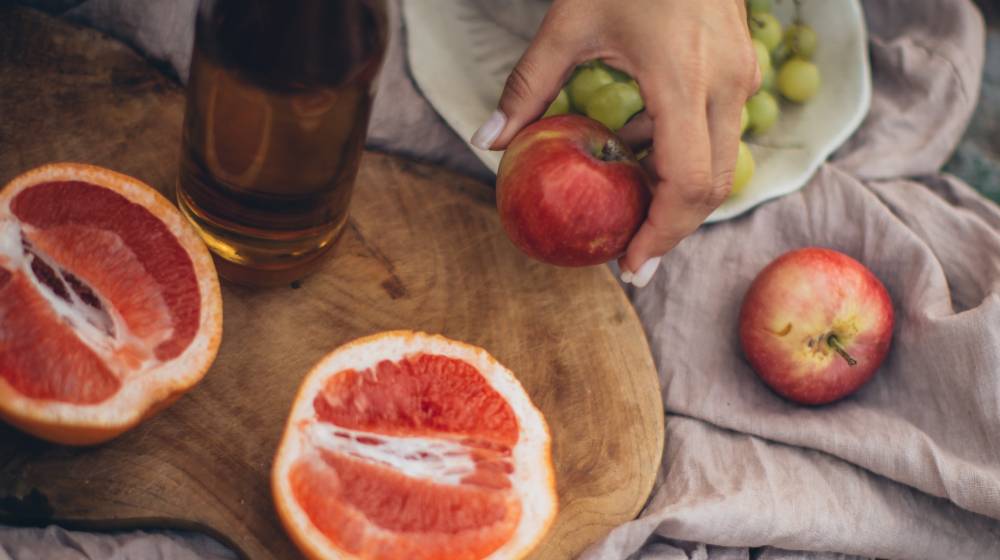 crop-woman-having-fresh-healthy-snack | 16 Best Snacks for Weight Loss | Featured