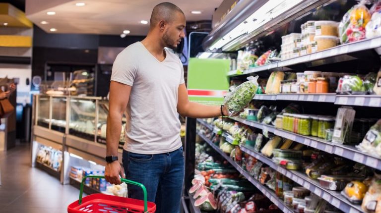 young-african-man-buying-vegetables-grocery | How to Make Your Grocery Trips Healthier | featured