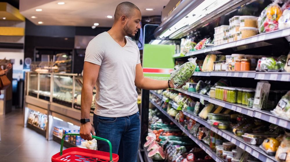 young-african-man-buying-vegetables-grocery | How to Make Your Grocery Trips Healthier | featured