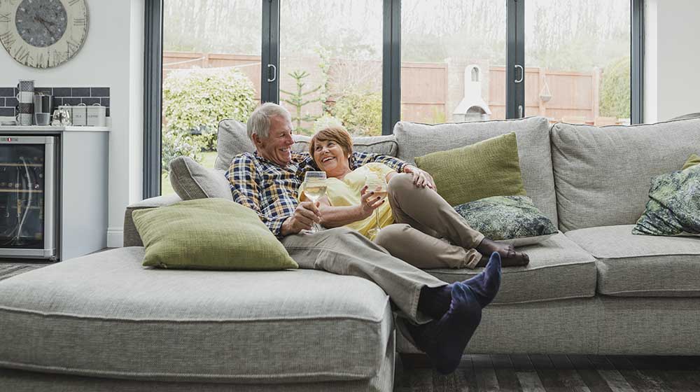 senior couple cuddling in the living room | Fun Hobbies For Couples Who Are Over 50 | Featured