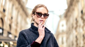 woman wearing black coat and brown framed sunglasses | Habits That Help Prevent Wrinkles | Featured