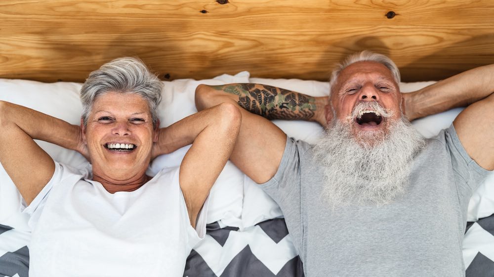 Happy senior couple in bed | penis exercises | featured | ss