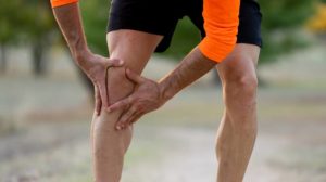 young-fit-man-holding-knee-his joint pain relief | Featured