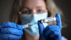 covid vaccine researcher hands female doctor | Is Mandatory Covid Vaccine Happening? Everything We Need To Know About The Covid-19 Vaccination | Featured