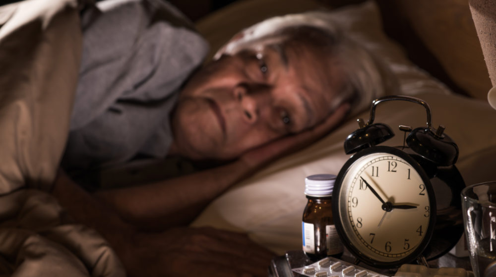 depressed senior man lying bed cannot sleep | Chronic Insomnia | Everything You Need To Know | Featured