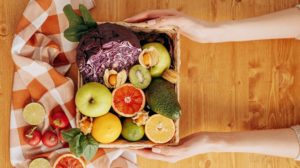 person holding a basket of fruits | Fibromyalgia Diet | Foods You Need To Eat And Avoid To Alleviate Symptoms | Featured