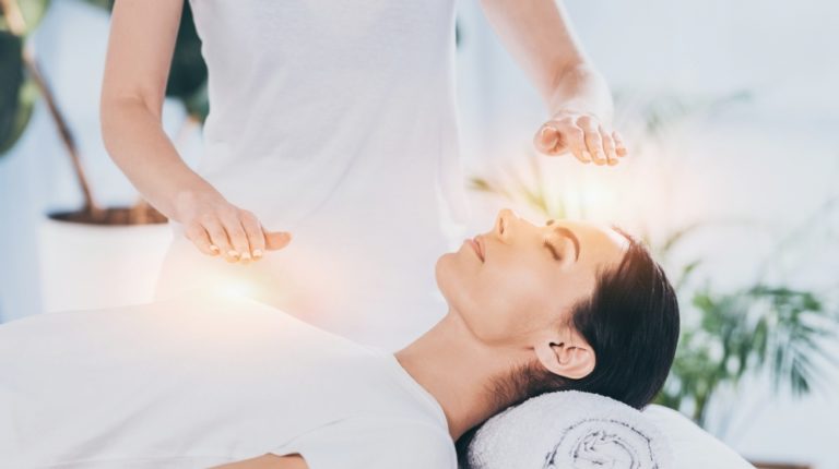 side view calm young woman receiving reiki healing | Reiki Healing Health Benefits | Featured
