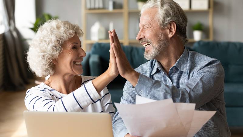 Excited older couple giving high five, mature family celebrating success | Investment Plan for Your Retirement