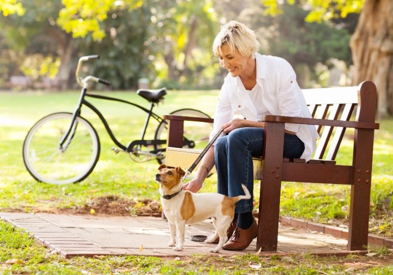 Happy-mature-woman-with-pet-dog-outdoors | things to do when you turn 50 years old