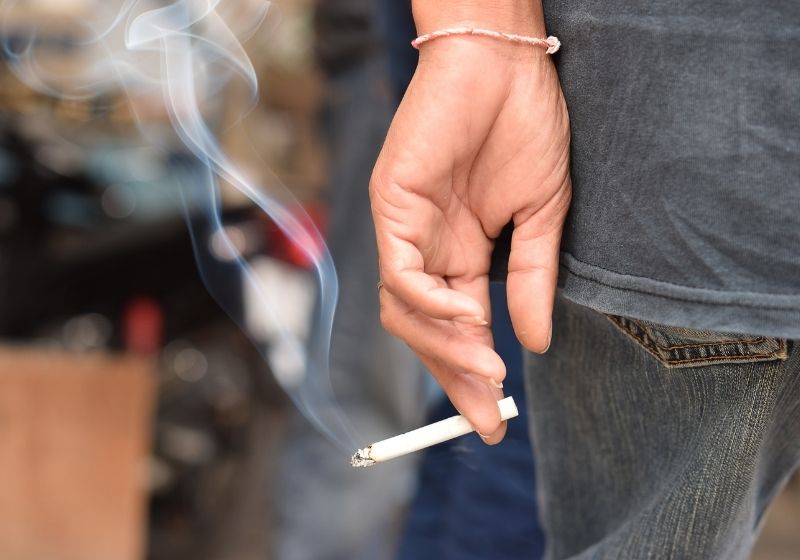 Image of cigarette in man hand with smoke When you turn 50 SS