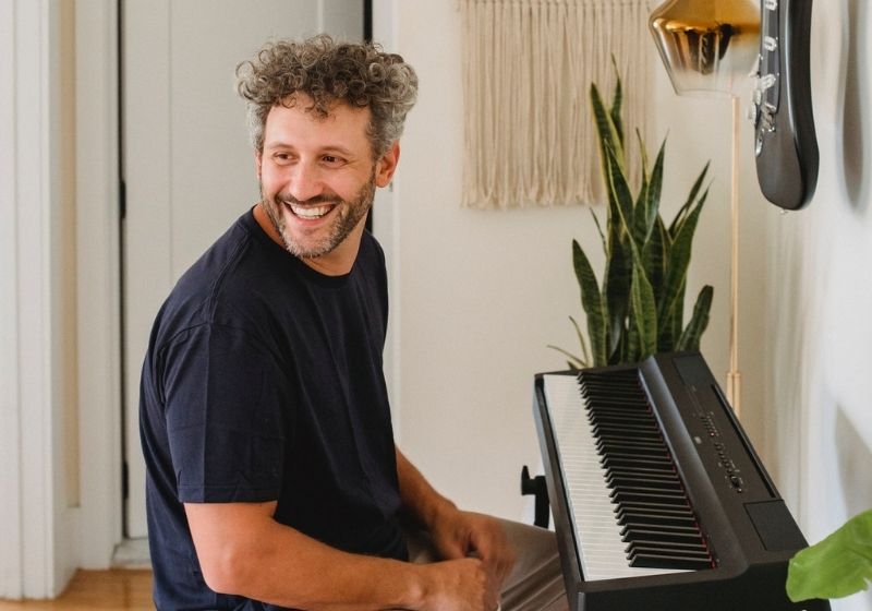 Smiling man with modern piano | what to expect when you hit your 50