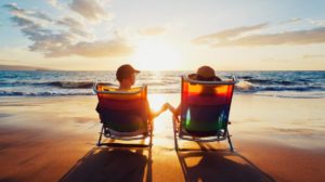 Happy Romantic Couple Enjoying Beautiful Sunset at the Beach | What Is Retirement In The 21st Century? | Featured