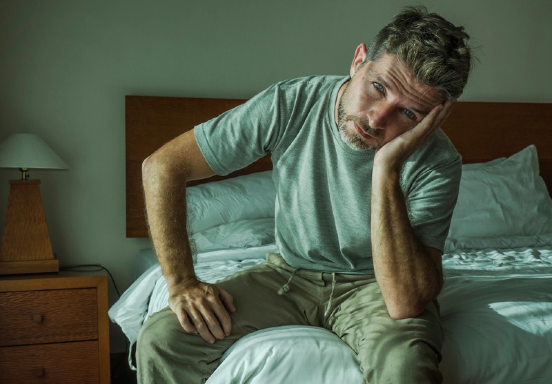 attractive depressed upset man home bedroom | what causes dementia