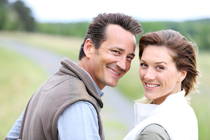 cheerful 40yearold couple walking countryside | master plan on aging in california