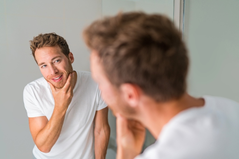 Man Looking in the Mirror | Things to Do When You Turn 50 Years Old