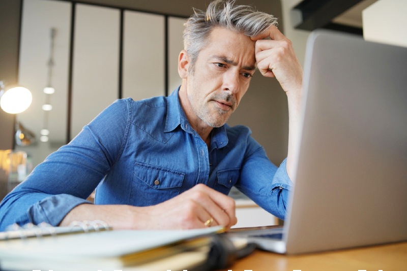 mature man working home looking stressed | prostatitis: causes