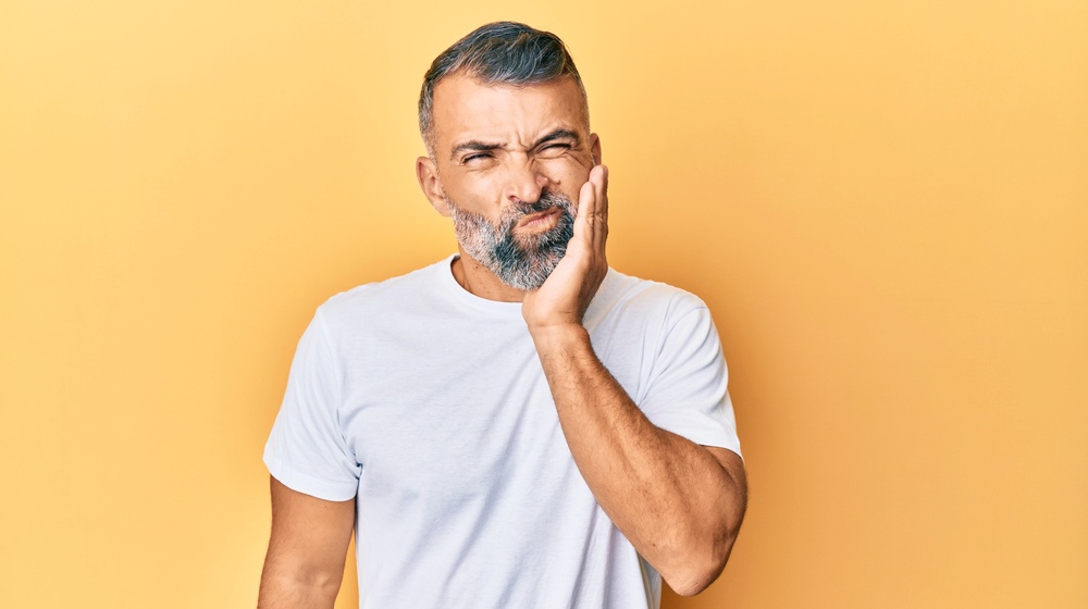 middle age handsome man wearing casual | How To Treat Sensitive Teeth | Causes & Symptoms Discussed | Featured