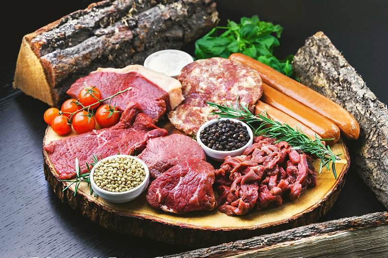 sliced meat on brown wooden round plate | foods to avoid