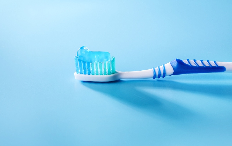 toothbrush toothpaste on blue background | Sensitive teeth home remedy