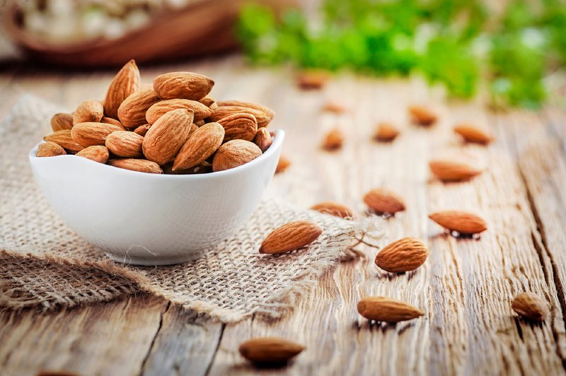 almonds white porcelain bowl on wooden | oods that will lower high blood pressure