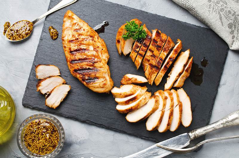 grilled chicken fillets on slate plate | foods that lower high blood pressure list