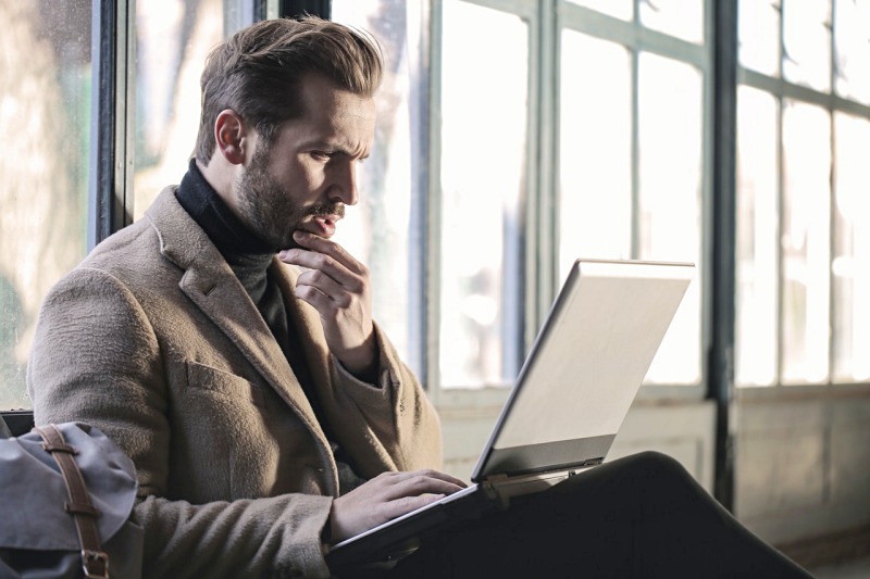 man wearing brown jacket and using grey laptop | what are the effects of a high sugar diet