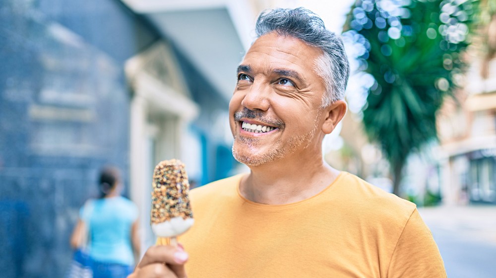 middle age greyhaired man smiling happy | Is Your Mental Health Affected by High-Sugar Diets | Featured
