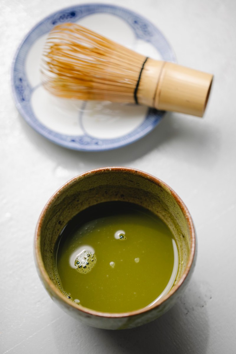 mixture of green tea in ceramic dishware | best foods for men over 50