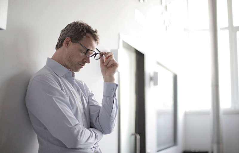 photo of man holding black eyeglasses | health effects of high sugar diet