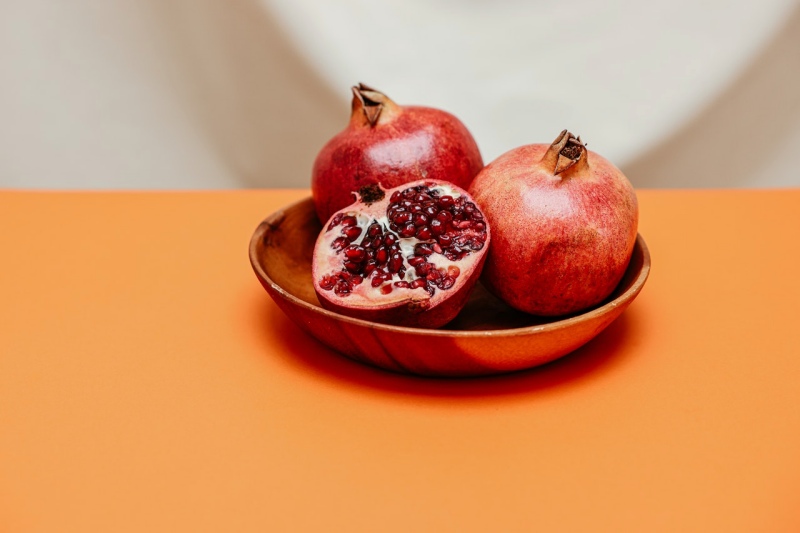 red round fruit on brown ceramic bowl | best foods for men over 50