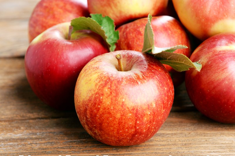ripe red apples on wooden background | foods that lower high blood pressure and cholesterol