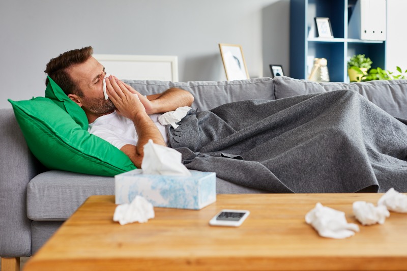 Sick Man Lying on Sofa | Stress Symptoms
