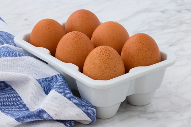 six organic eggs on white tray | Diabetic meaning