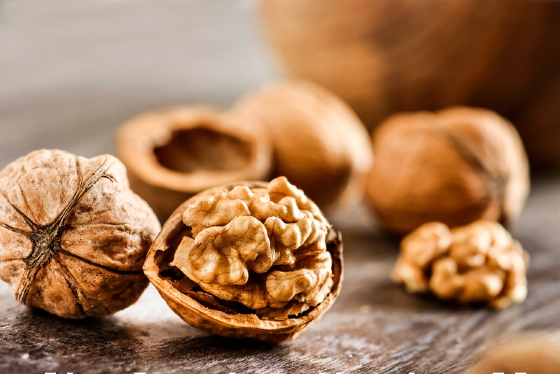 walnuts kernels on dark desk color | foods that lower high blood pressure quickly