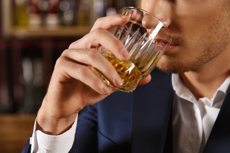 Closeup of Man Drinking Whiskey | Sleep Hygiene