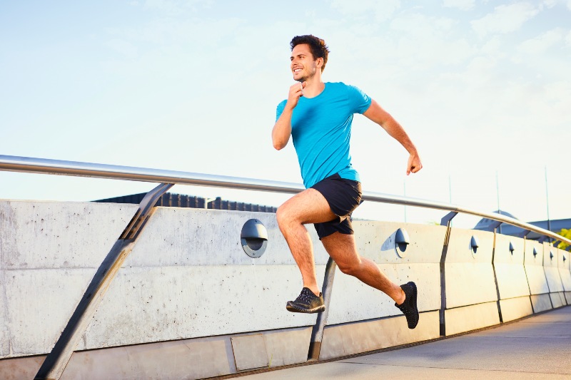 Happy Man Running on Bridge | Vitamin D Benefits