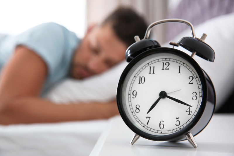 Man Sleeping Focus on Alarm Clock | Sleep Hygiene