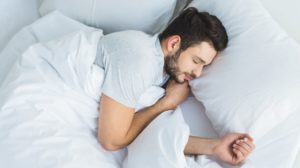 Man Sleeping on Bed | Sleep Hygiene | Featured