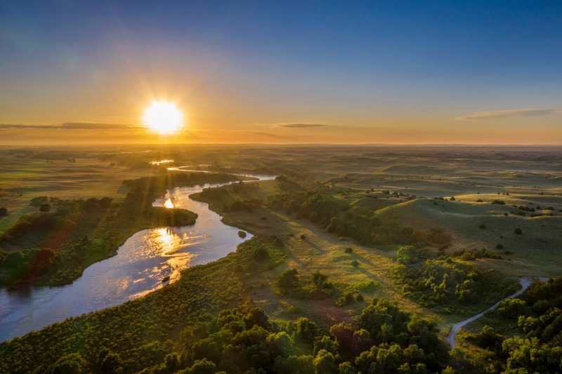 sunrise over dismal river meandering through | best places to retire in the world