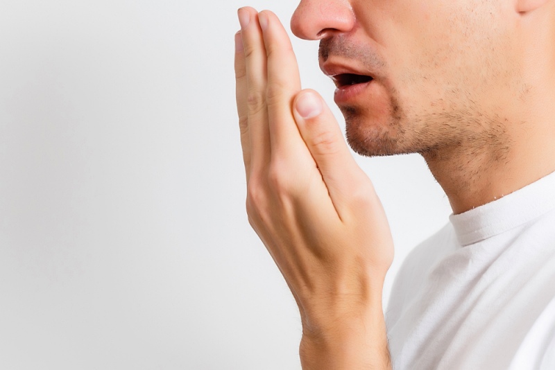 bad breath halitosis concept young man | symptoms of kidney problems