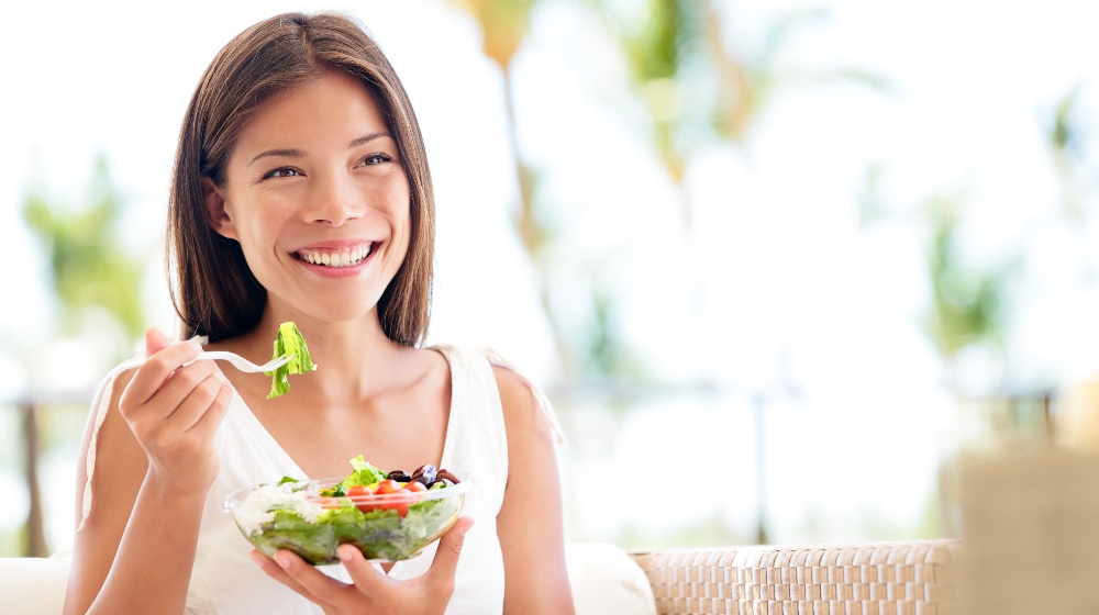 Healthy Lifestyle Woman Eating Salad Smiling | Diindolylmethane | Featured