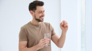 Man Taking a Supplement | CoQ10 Benefits | Featured