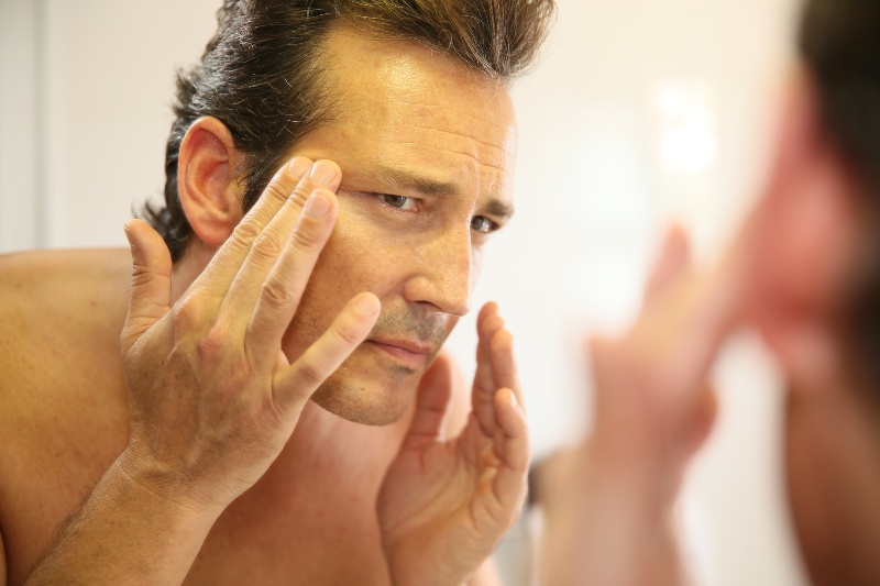 Man Touching His Face | CoQ10 Benefits