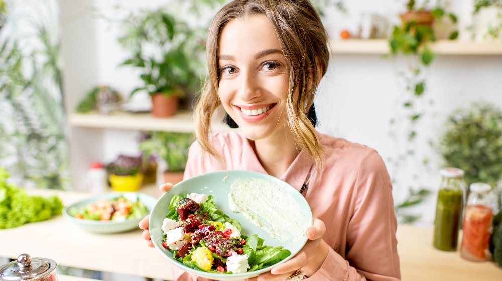 Woman Holding a Plate of Salad | Keto Paleo | Featured