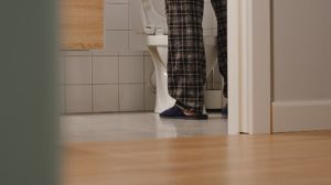 Adult man in a toilet at home | After-Dribble (A Common Problem For Men) | featured