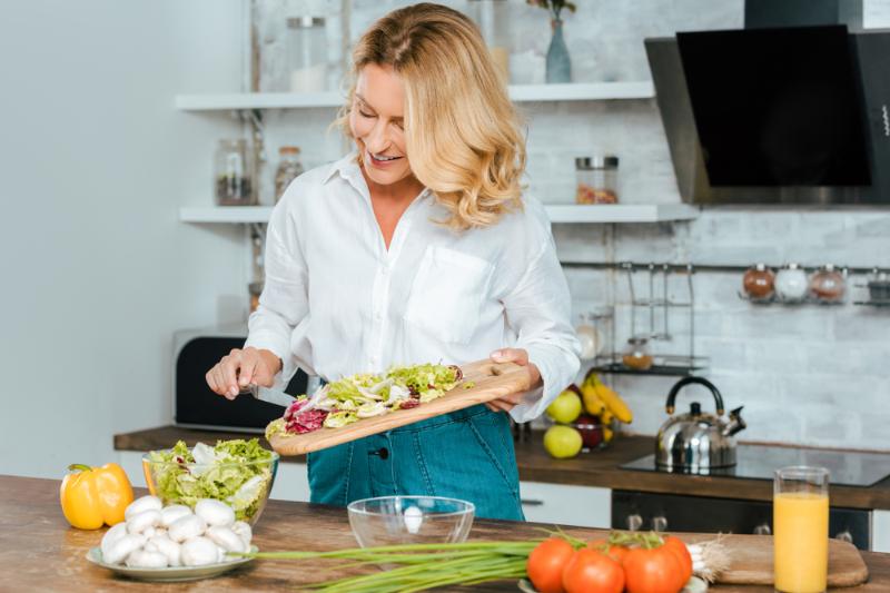 beautiful-adult-woman-making-healthy-salad | healthy benefits of liquid chlorophyll