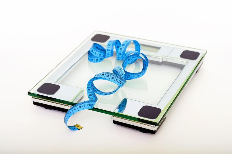 blue tape measuring on clear glass square weighing scale omad benefits PX 1