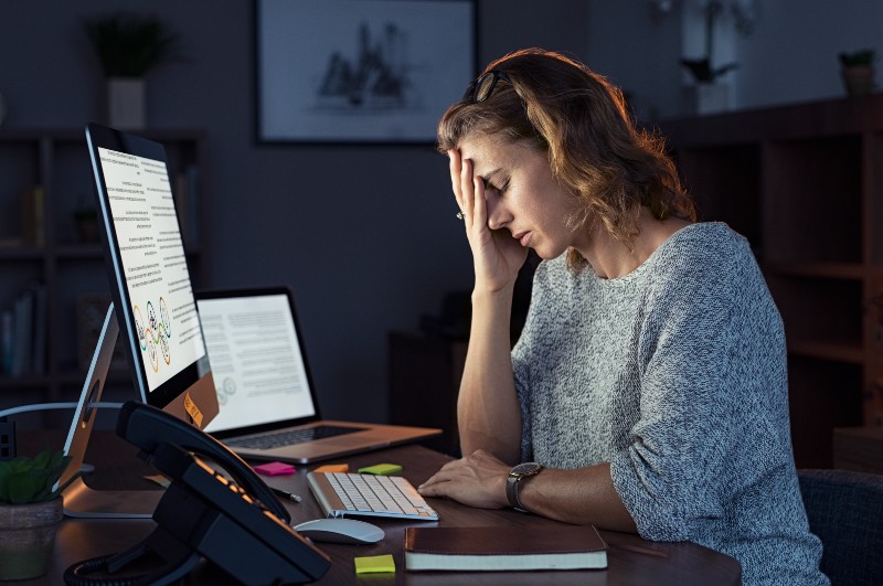 Matured Tired Businesswoman Working on Computer | Hyperparathyroid Symptoms