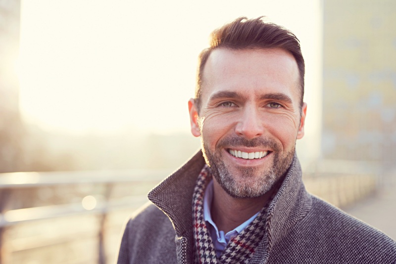 portrait happy man smiling outdoors during at home testosterone test